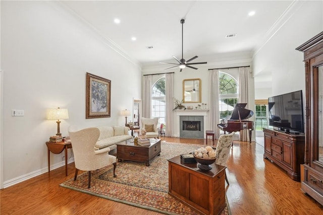 10 Catalpa Trce, Covington, LA 70433 - living room featuring a fireplace, ceiling fan, wood finished floors, ornamental molding, and recessed lighting