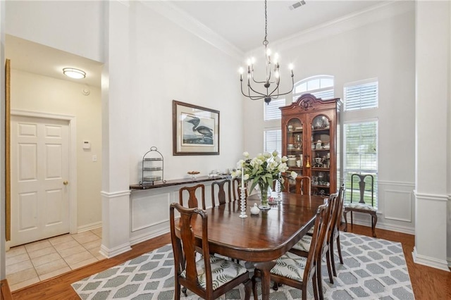 10 Catalpa Trce, Covington, LA 70433 - dining area with a chandelier, wood finished floors, a towering ceiling, and ornamental molding