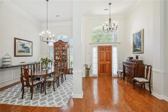 10 Catalpa Trce, Covington, LA 70433 - entryway with a chandelier, wood finished floors, ornamental molding, a towering ceiling, and baseboards