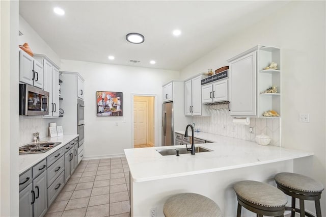 10 Catalpa Trce, Covington, LA 70433 - kitchen with a sink, open shelves, stainless steel appliances, backsplash, and recessed lighting
