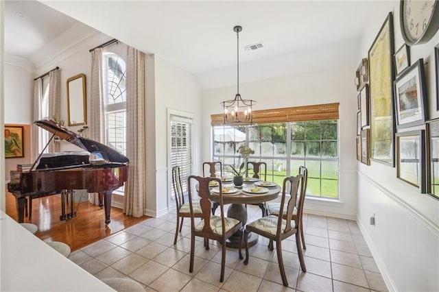 10 Catalpa Trce, Covington, LA 70433 - dining space with a chandelier, light tile patterned flooring, and baseboards