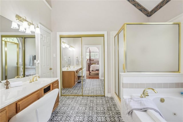 bathroom featuring shower with separate bathtub and vanity