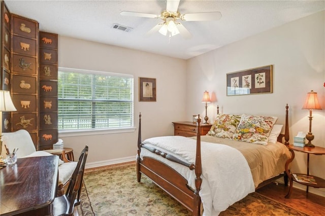 bedroom with ceiling fan and hardwood / wood-style flooring