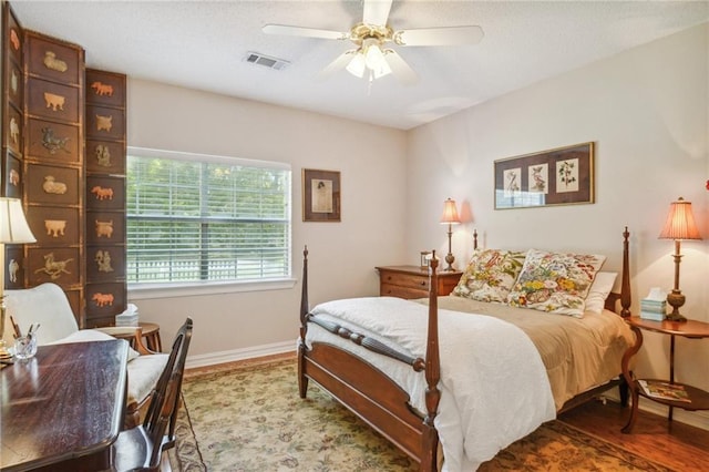 10 Catalpa Trce, Covington, LA 70433 - bedroom with baseboards, wood finished floors, ceiling fan, and a textured ceiling