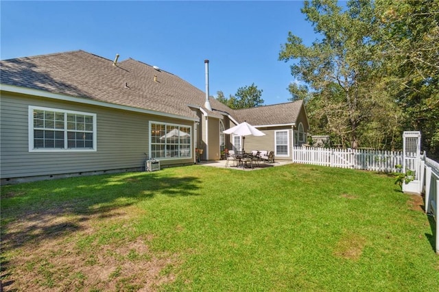 rear view of house featuring a patio and a yard