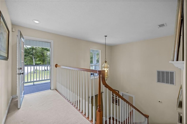 hallway with light colored carpet