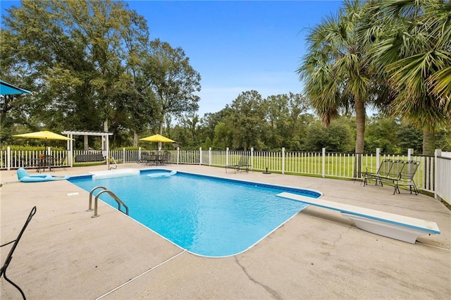 view of swimming pool featuring a diving board, a pergola, and a patio area