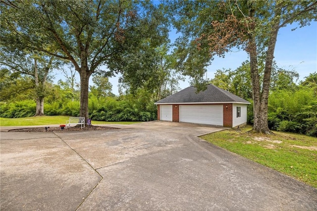 view of property exterior with a garage and a yard