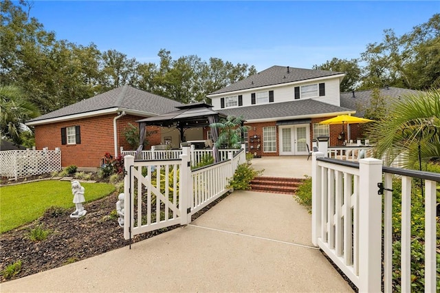 view of front facade with french doors and a gazebo