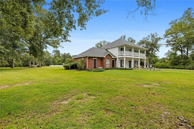 view of front of home featuring a balcony and a front yard