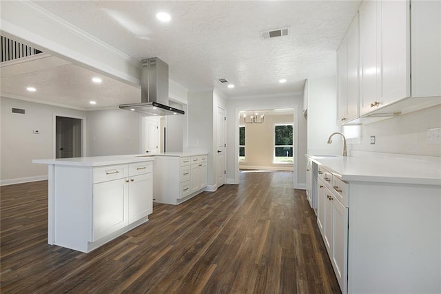 kitchen featuring white cabinetry, kitchen peninsula, dark hardwood / wood-style flooring, sink, and wall chimney range hood