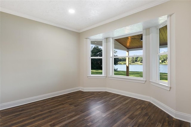 empty room featuring ornamental molding, a textured ceiling, dark hardwood / wood-style flooring, and a water view