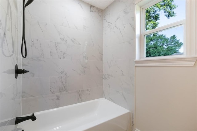 bathroom featuring tiled shower / bath and plenty of natural light