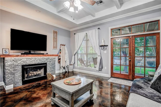 living room featuring ceiling fan, beamed ceiling, crown molding, and a tile fireplace