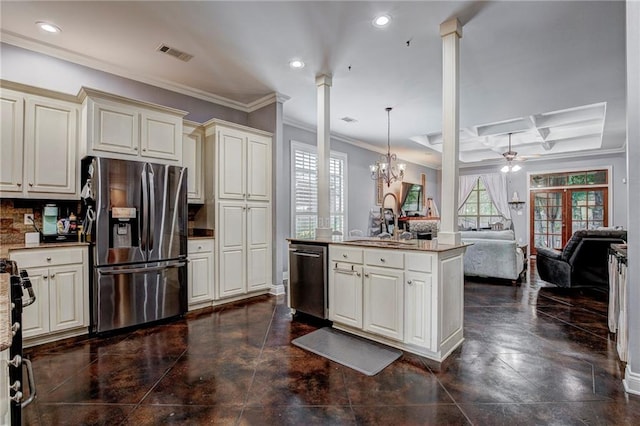 kitchen featuring ceiling fan with notable chandelier, appliances with stainless steel finishes, plenty of natural light, and hanging light fixtures