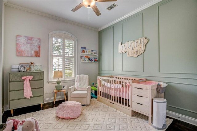 18 Pin Oak Ln, Hammond, LA 70401 - bedroom featuring a nursery area, ornamental molding, baseboards, and a ceiling fan