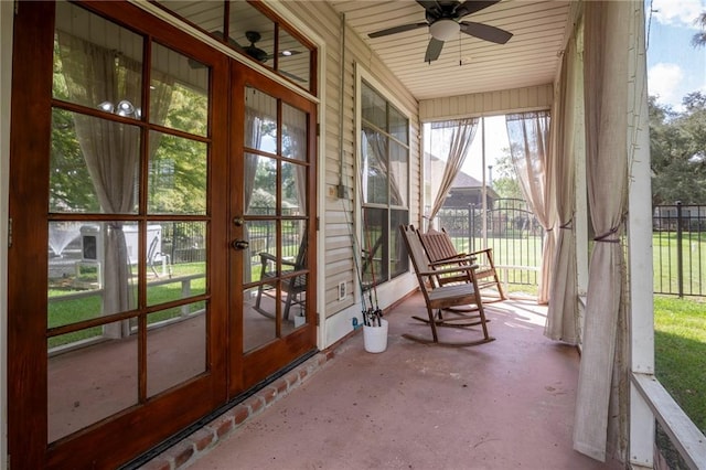 unfurnished sunroom featuring ceiling fan