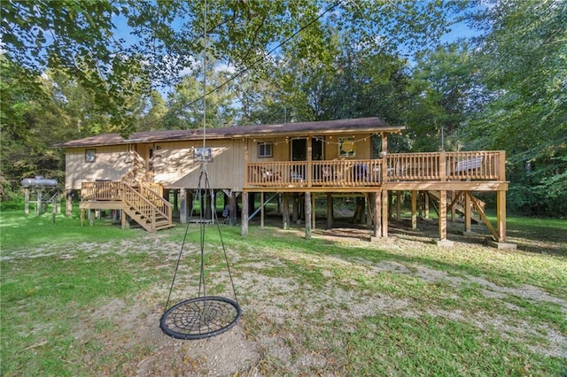 rear view of house with a deck and a yard