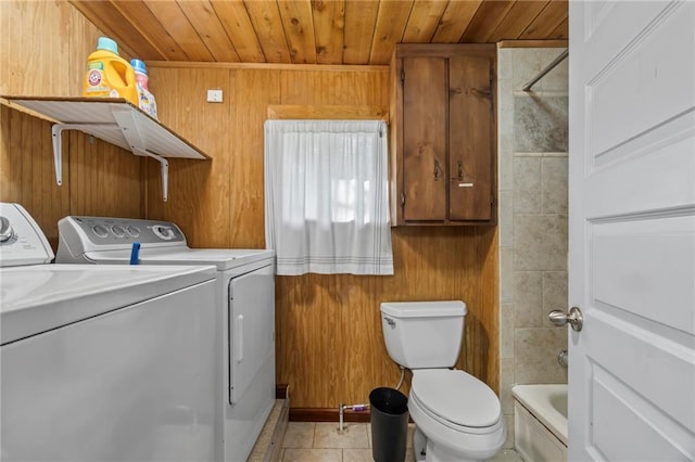 laundry area featuring wood ceiling, wood walls, light tile patterned floors, and washer and clothes dryer