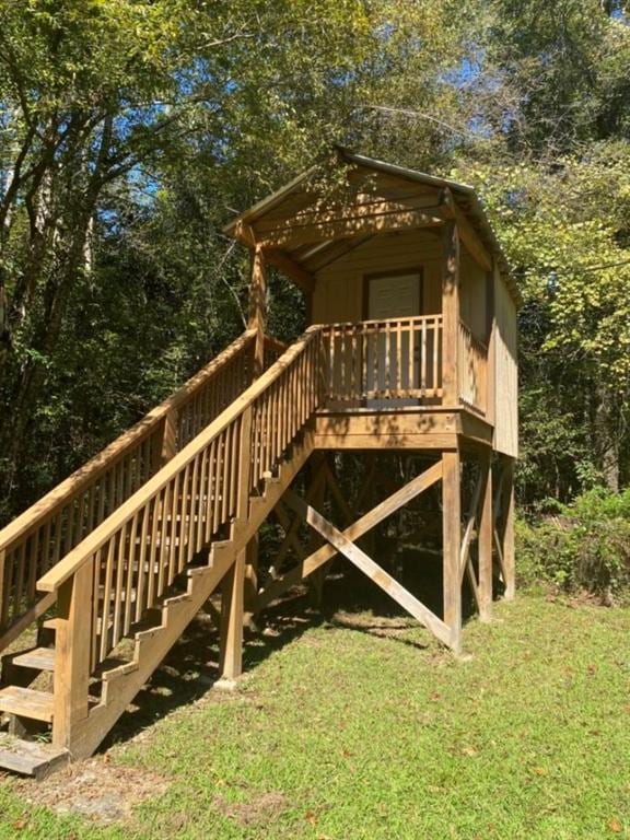 exterior space featuring a yard and a wooden deck