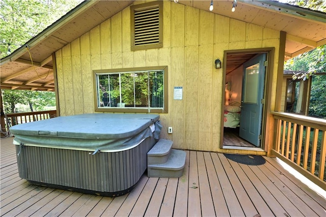 wooden terrace with a hot tub