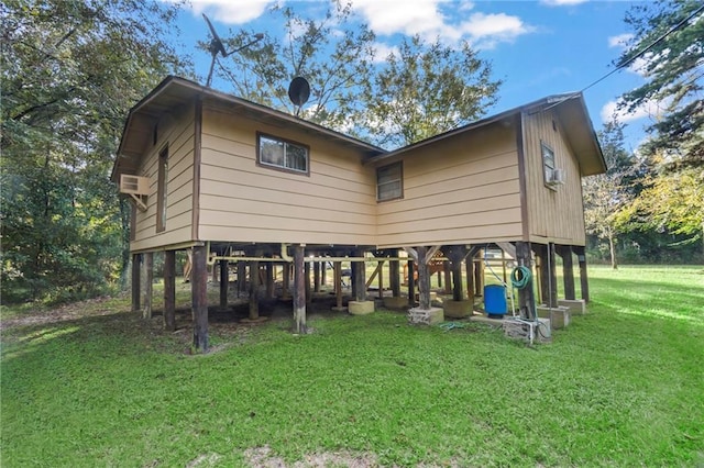 rear view of house featuring a lawn