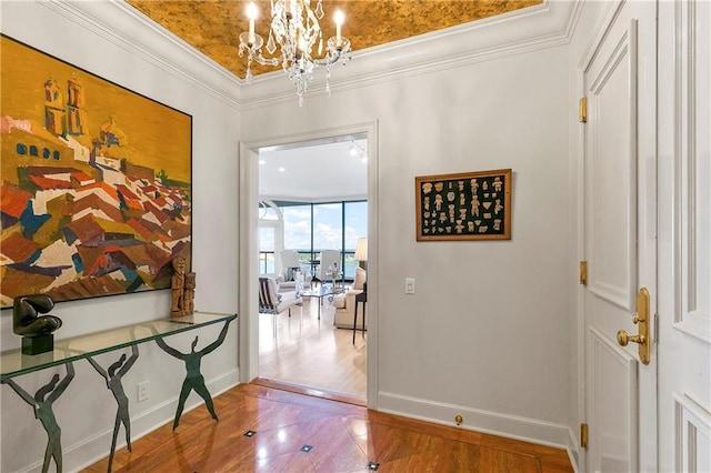 corridor with crown molding, an inviting chandelier, and hardwood / wood-style flooring