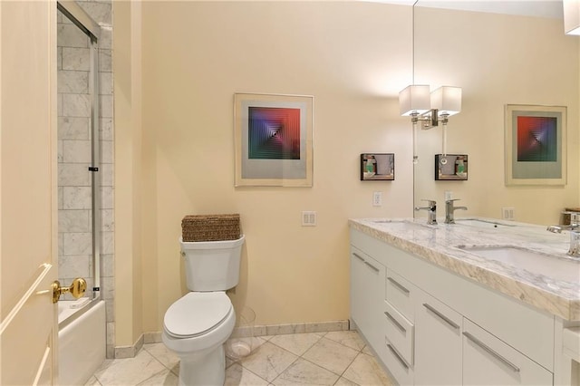 full bathroom featuring enclosed tub / shower combo, vanity, and toilet