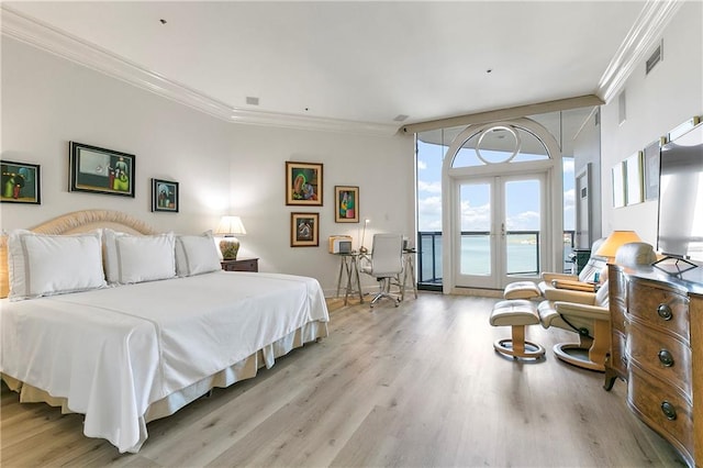 bedroom featuring crown molding, access to outside, light hardwood / wood-style flooring, and french doors