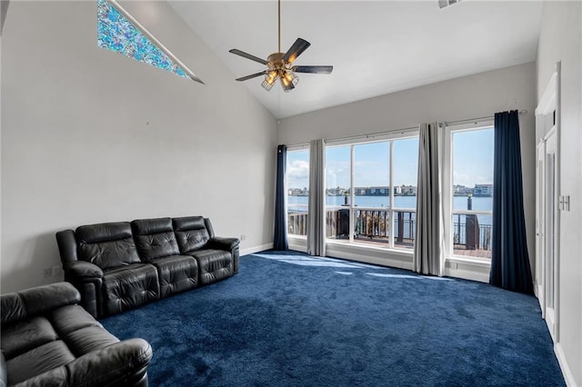 carpeted living room with high vaulted ceiling, ceiling fan, and a water view