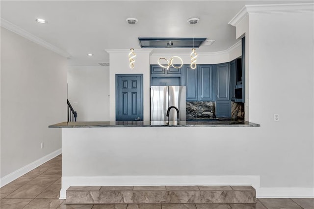 kitchen with crown molding, blue cabinetry, stainless steel refrigerator, and kitchen peninsula