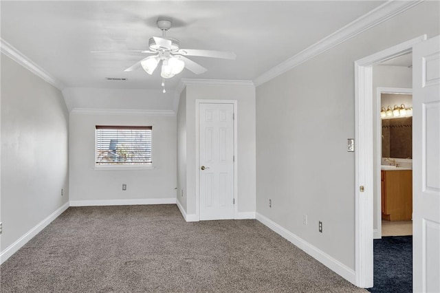 unfurnished bedroom with ornamental molding, ceiling fan, and carpet