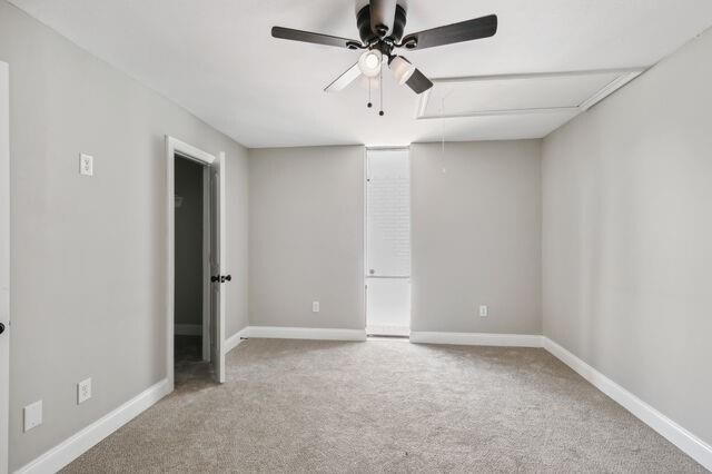 carpeted spare room with ceiling fan