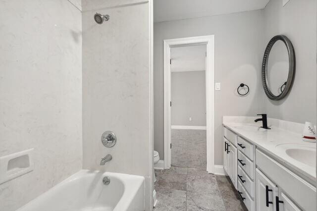 full bathroom featuring vanity, toilet, and tiled shower / bath