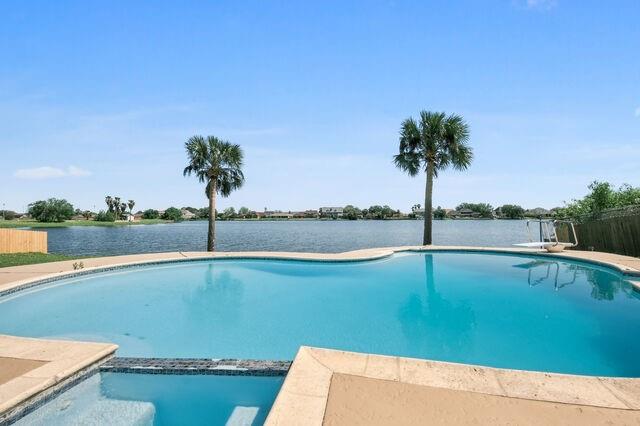 view of swimming pool featuring a water view