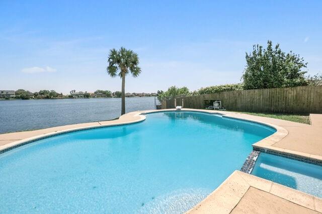 view of swimming pool with a water view