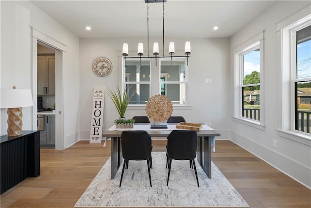 dining room featuring light hardwood / wood-style floors and a chandelier