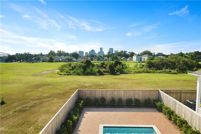 view of swimming pool with a patio and central air condition unit