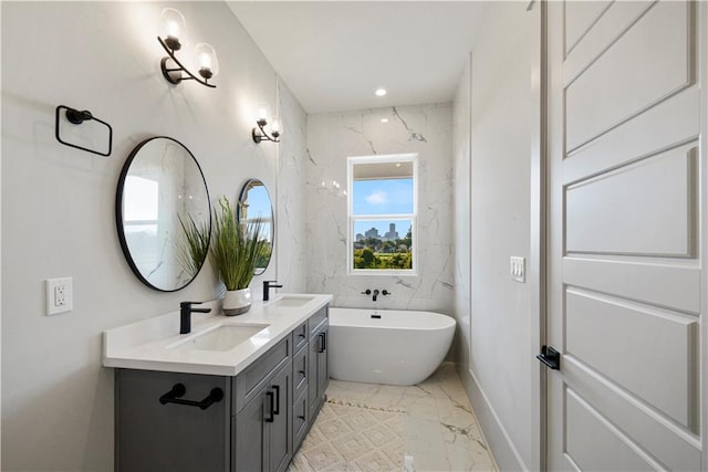 bathroom featuring vanity and a tub