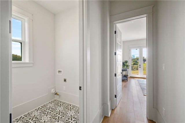 corridor featuring a wealth of natural light and light hardwood / wood-style floors