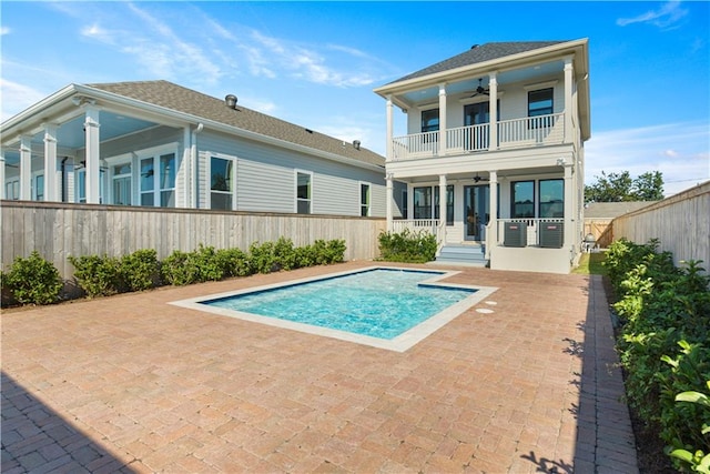 view of swimming pool featuring ceiling fan and a patio area