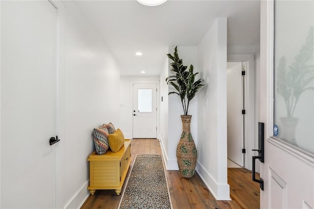 interior space featuring recessed lighting, baseboards, and hardwood / wood-style flooring