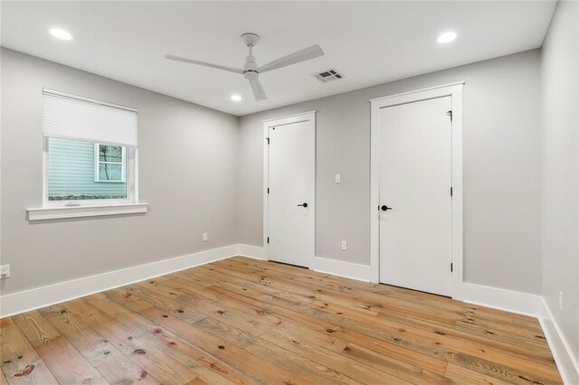 unfurnished bedroom with ceiling fan and hardwood / wood-style floors