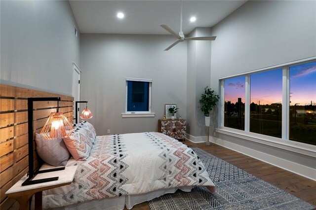 bedroom featuring high vaulted ceiling, ceiling fan, and hardwood / wood-style flooring