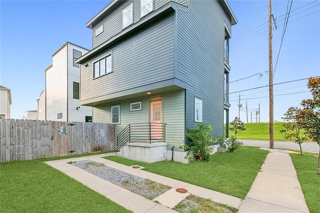 view of front of property with fence and a front yard