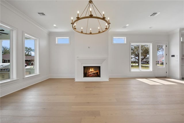 unfurnished living room with ornamental molding, a notable chandelier, and light hardwood / wood-style floors