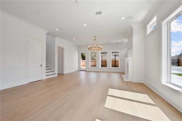 unfurnished living room with light wood-type flooring and plenty of natural light