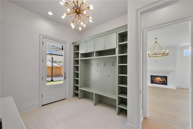 mudroom featuring a notable chandelier and hardwood / wood-style flooring