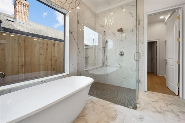 full bath with a freestanding bath, marble finish floor, and a marble finish shower