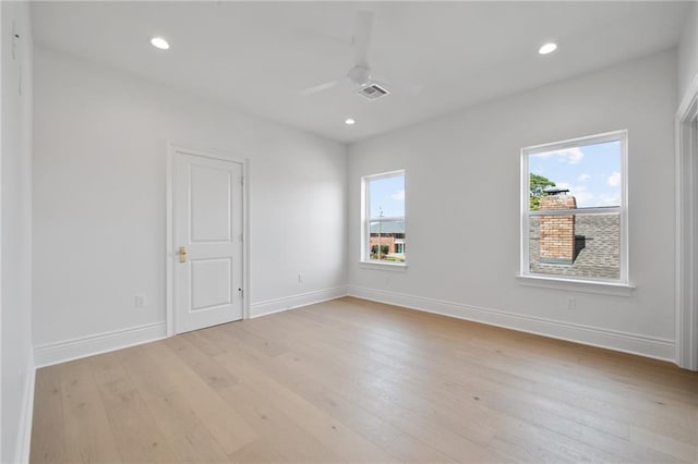 unfurnished room featuring ceiling fan, light wood-type flooring, and a wealth of natural light